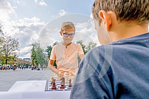 Kids playing chess game in Lukiskes square, Vilnius, Lithuania