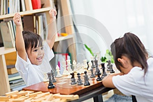 Kids playing chess - one of them just captured a pawn and celebrates