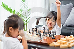 Kids playing chess - one of them just captured a pawn and celebrates