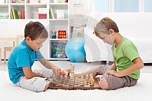 Kids playing chess in their room