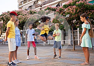 Kids playing with chinese jumping rope outdoors