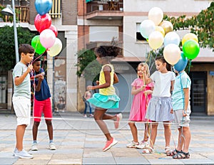 Kids playing with Chinese jumping rope outdoors