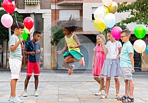 Kids playing with Chinese jumping rope outdoors