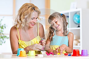 Kids playing with colorful clay molding different