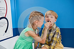 Kids playing doctor and patient.