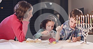 Kids playing with dreidels during Hanukka at home