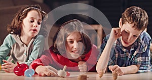 Kids playing with dreidels during Hanukka at home