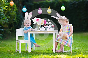Kids playing Easter tea party with toys