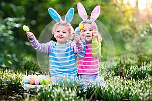 Kids playing with eggs busket on Easter egg hunt