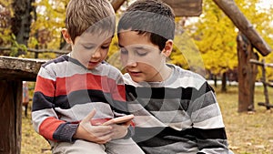 Kids playing with electrical gadgets. Children playing in online games