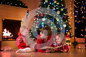 Kids playing at fireplace on Christmas eve