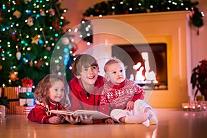 Kids playing at fireplace on Christmas eve