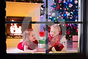 Kids playing at fireplace on Christmas eve