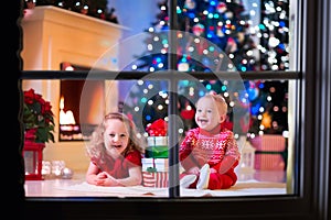 Kids playing at fireplace on Christmas eve