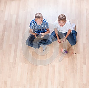 Kids playing with flying helicopter model at home using remote control