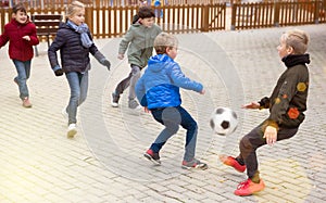 Kids playing football outdoors