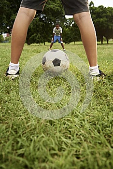 Kids playing football and soccer game in park