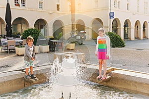 Kids playing by the fountain on summer day