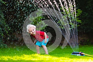 Kids playing with garden sprinkler