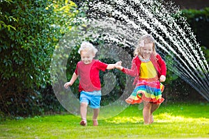 Kids playing with garden sprinkler