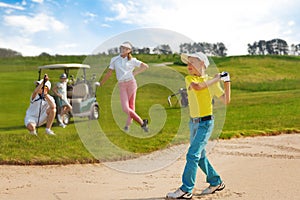 Kids playing golf