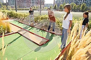 Kids playing golf inside playground artificial grass activity game for children