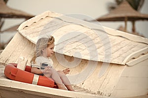 Kids playing - happy game. Boy little child sitting in life ring.