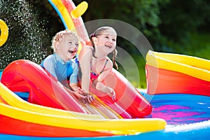 Kids playing in inflatable swimming pool