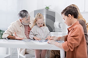 kids playing jigsaw puzzle game with