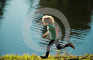 Kids playing on lake. Children play on summer family vacation. Outdoor sports and fitness for children. Sporty young