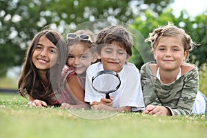 Kids playing with magnifying glass