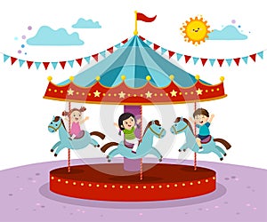 Kids playing on merry go round in an amusement park