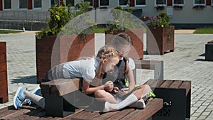 Kids Playing With Mobile Phone In Schoolyard