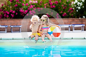 Kids playing at outdoor swimming pool