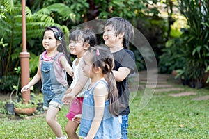 Kids playing outdoors with friends. little children play at nature park.