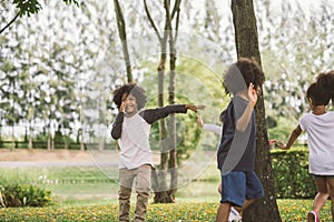 Kids playing outdoors with friends. little children play at nature park.