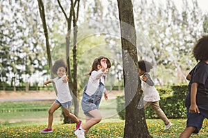 Kids playing outdoors with friends. little children play at nature park. photo