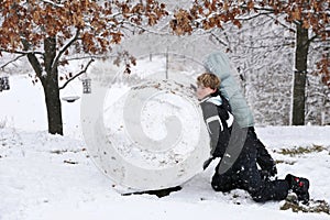 Kids Playing Outside in the Snow and Making a Huge Snowball