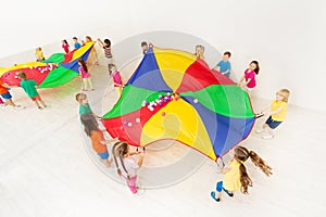 Kids playing parachute games in light gym