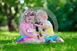 Kids playing with pet rabbit