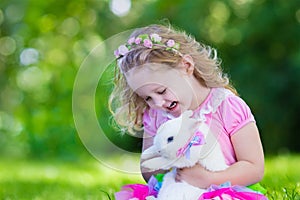 Kids playing with pet rabbit