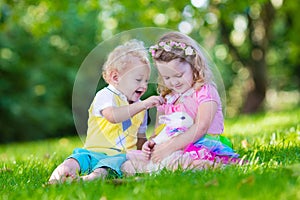 Kids playing with pet rabbit