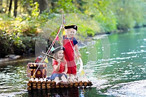 Kids playing pirate adventure on wooden raft