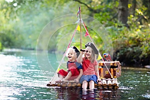 Kids playing pirate adventure on wooden raft