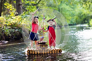 Kids playing pirate adventure on wooden raft