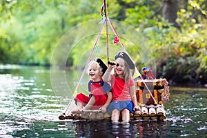 Kids playing pirate adventure on wooden raft