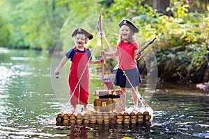 Kids playing pirate adventure on wooden raft