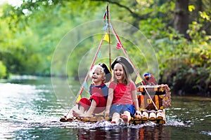 Kids playing pirate adventure on wooden raft