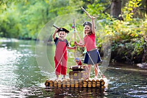 Kids playing pirate adventure on wooden raft