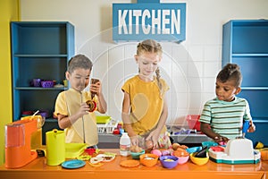 Kids playing with plastic food at daycare.